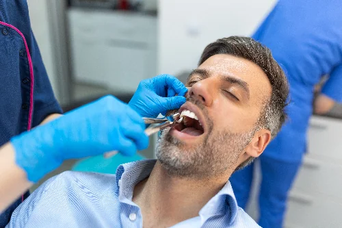man having a tooth pulled in Wilmette